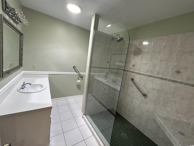 bathroom with tiled shower, vanity, and tile patterned floors