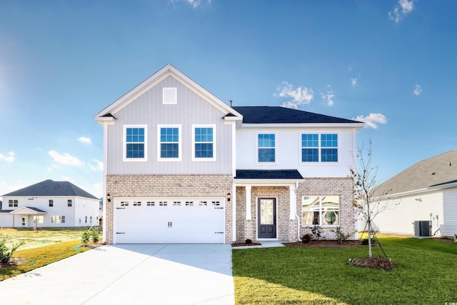 view of front of home featuring cooling unit, a garage, and a front lawn