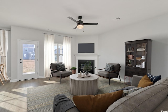 living room featuring ceiling fan and light hardwood / wood-style flooring