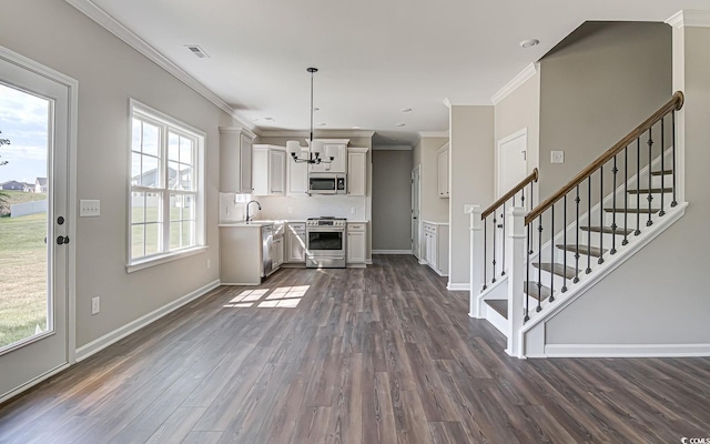 kitchen featuring pendant lighting, backsplash, dark hardwood / wood-style flooring, ornamental molding, and stainless steel appliances