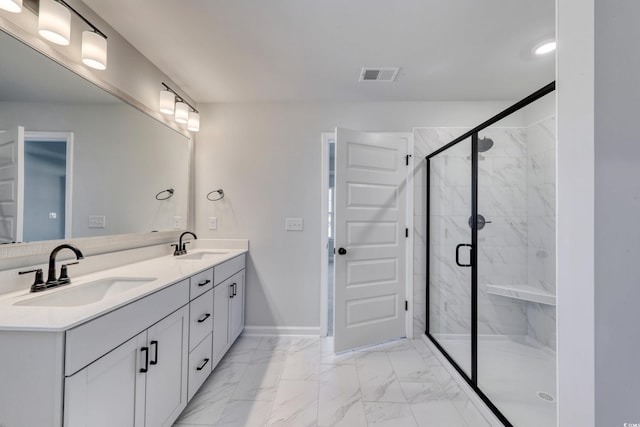 bathroom with vanity and a shower with door