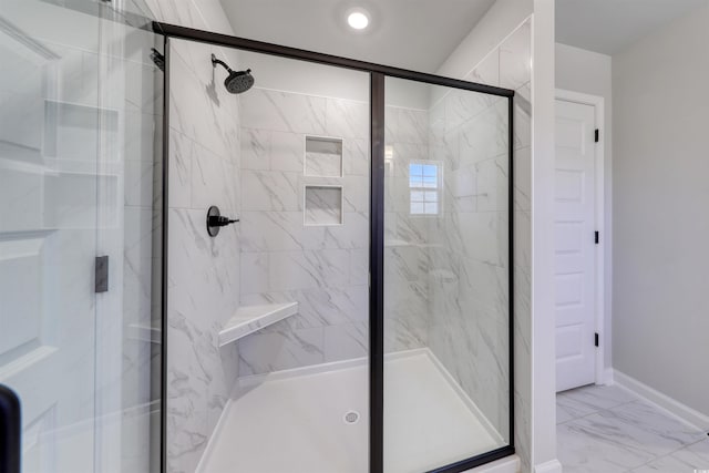 bathroom featuring a shower with door