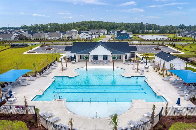 view of pool featuring a patio and a water view