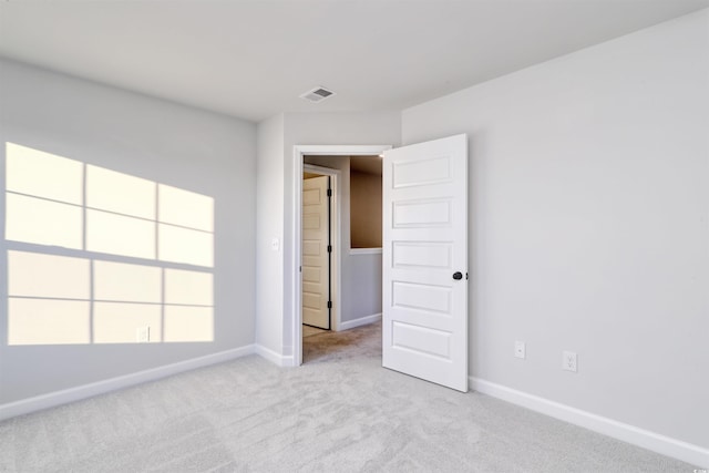 unfurnished bedroom featuring light colored carpet