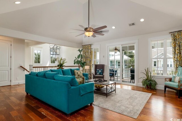 living room featuring ceiling fan, dark hardwood / wood-style floors, vaulted ceiling, and a healthy amount of sunlight