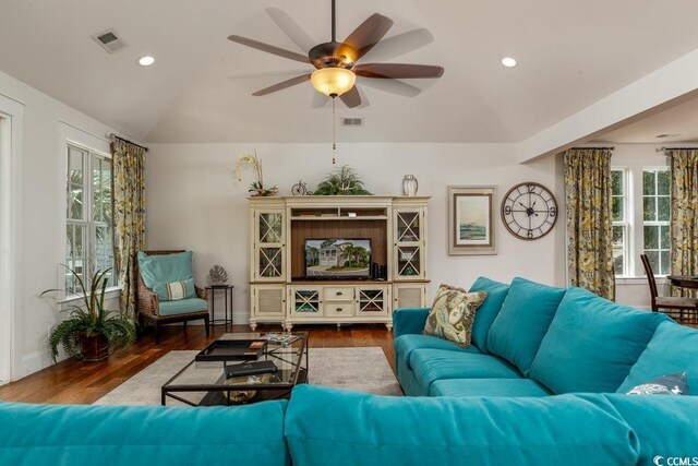 living room featuring vaulted ceiling, wood-type flooring, and ceiling fan