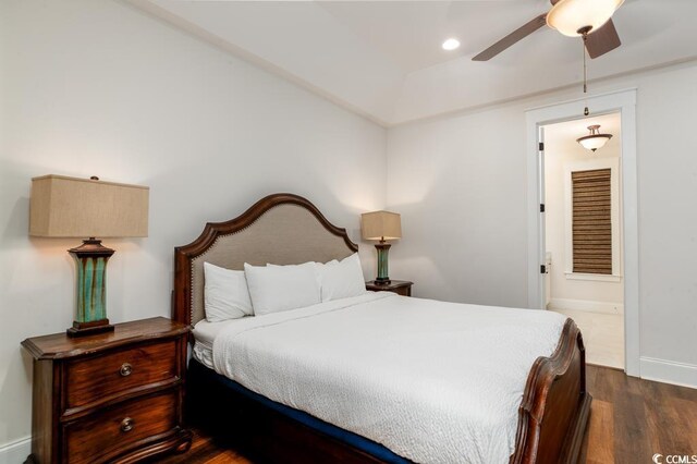 bedroom featuring connected bathroom, dark hardwood / wood-style floors, and ceiling fan