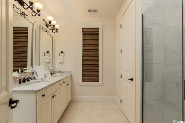 bathroom with a tile shower and vanity