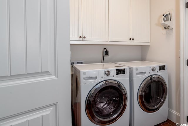 laundry area featuring washing machine and dryer and cabinet space