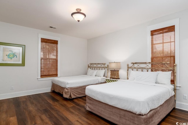 bedroom with dark hardwood / wood-style floors