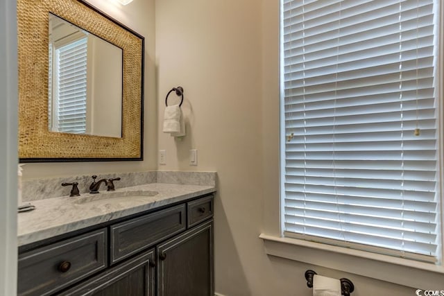 bathroom featuring a wealth of natural light and vanity