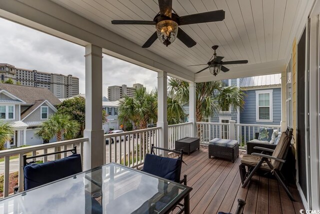 wooden deck with outdoor lounge area and ceiling fan