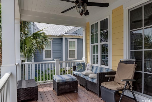 wooden terrace with ceiling fan and an outdoor living space