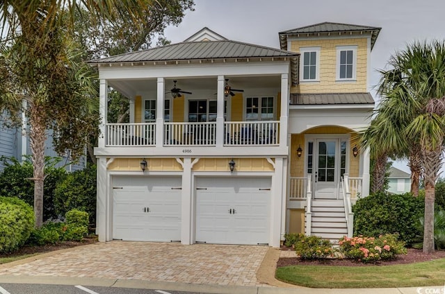 view of front of property featuring a garage, a porch, and ceiling fan