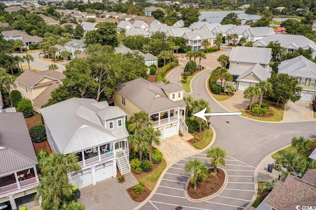 birds eye view of property with a water view and a residential view