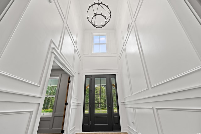 foyer with a notable chandelier and a healthy amount of sunlight