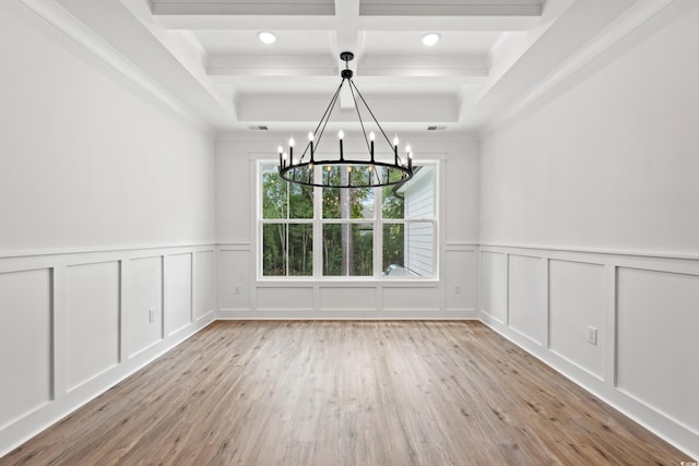 unfurnished dining area with beamed ceiling, light hardwood / wood-style flooring, crown molding, and a notable chandelier