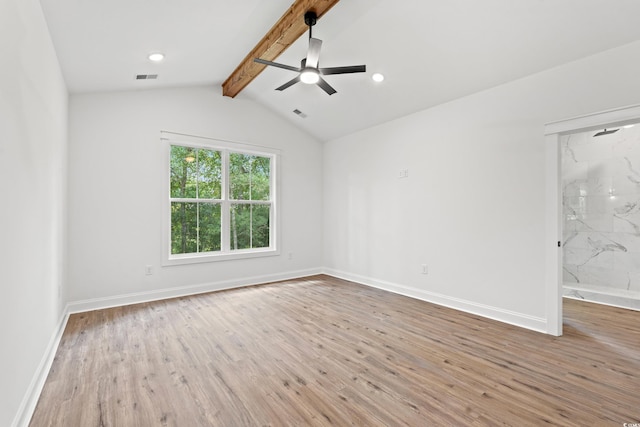 spare room with light wood-type flooring, vaulted ceiling with beams, and ceiling fan