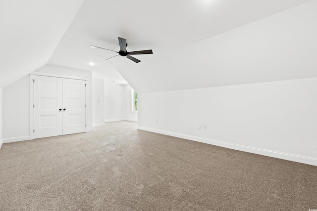 additional living space featuring ceiling fan, vaulted ceiling, and carpet