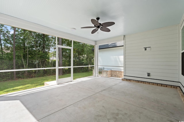 unfurnished sunroom featuring ceiling fan