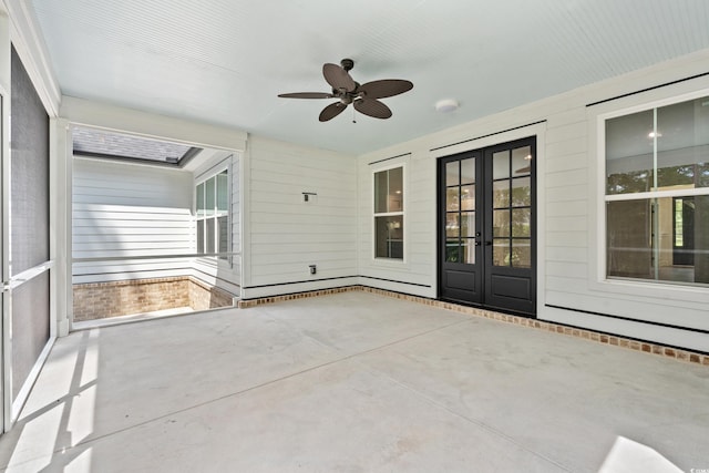 unfurnished sunroom featuring french doors and ceiling fan