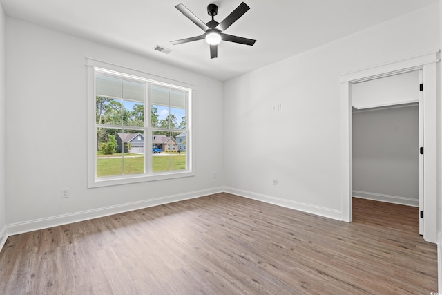 unfurnished room featuring hardwood / wood-style floors and ceiling fan