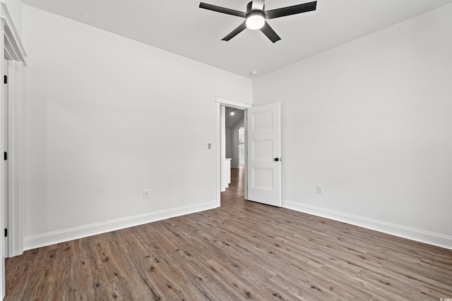 spare room with hardwood / wood-style floors and ceiling fan