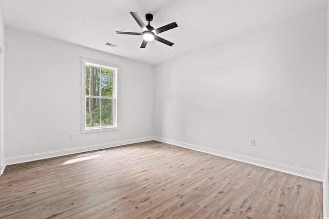 empty room featuring hardwood / wood-style flooring and ceiling fan