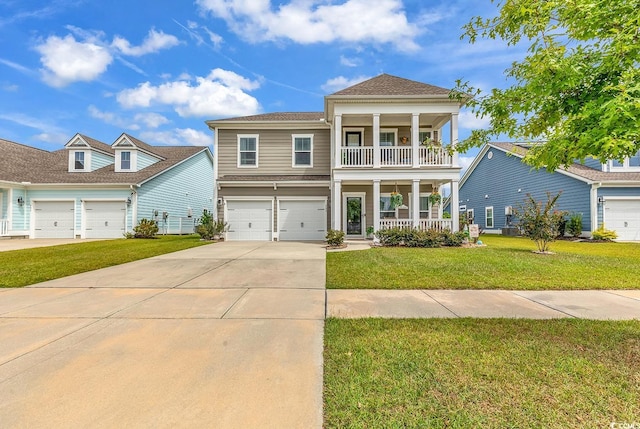 view of front of house with a garage, a front lawn, and covered porch