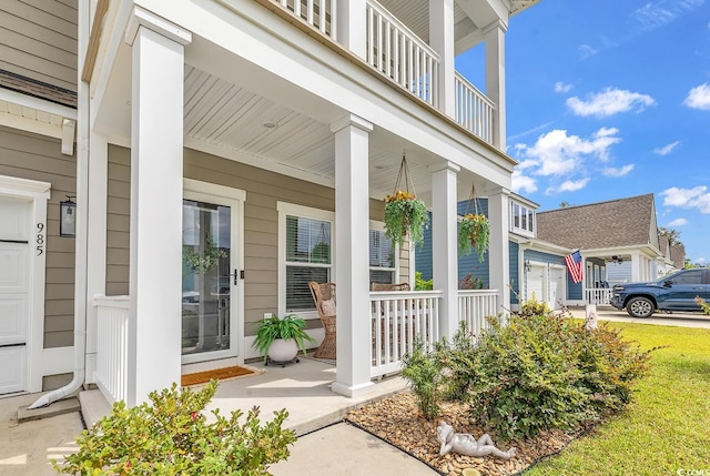 property entrance with covered porch and a balcony