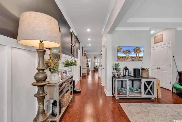 hall featuring dark wood-type flooring and ornamental molding