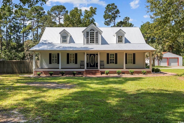 view of front of house featuring a garage, an outdoor structure, covered porch, and a front yard