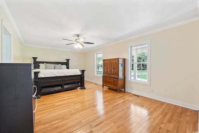 bedroom featuring crown molding, light hardwood / wood-style flooring, and ceiling fan