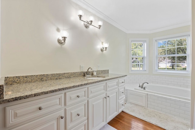 bathroom featuring crown molding, tiled bath, vanity, and wood-type flooring