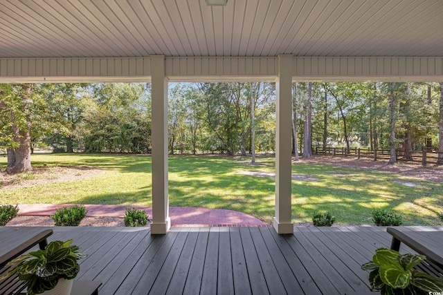 wooden deck featuring a lawn