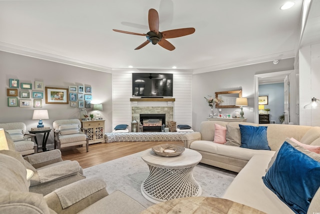 living room featuring a fireplace, light hardwood / wood-style flooring, and ornamental molding