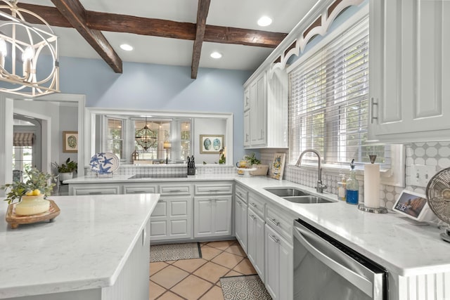 kitchen featuring stainless steel dishwasher, sink, backsplash, and a wealth of natural light