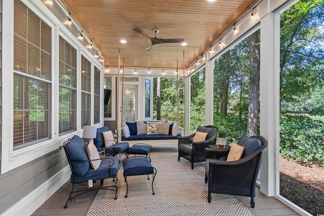 sunroom / solarium featuring ceiling fan and wooden ceiling