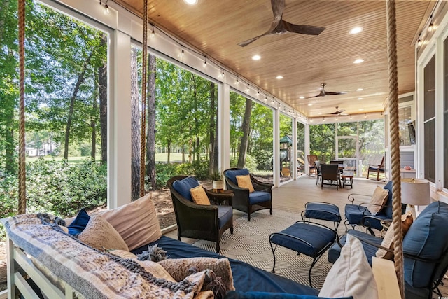 sunroom / solarium featuring ceiling fan, wooden ceiling, and a wealth of natural light