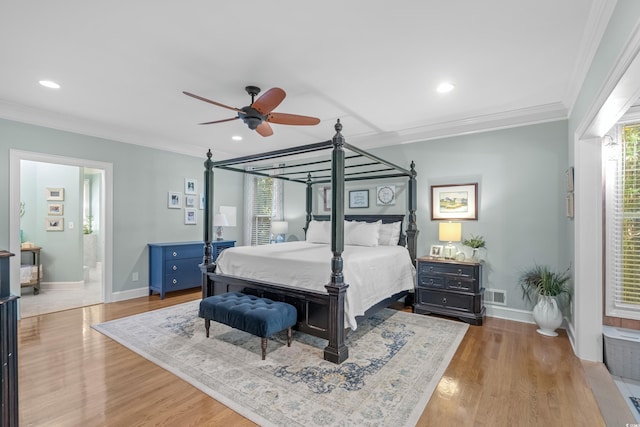 bedroom with ceiling fan, crown molding, light hardwood / wood-style flooring, and ensuite bath