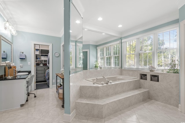 bathroom with tiled tub, crown molding, and vanity