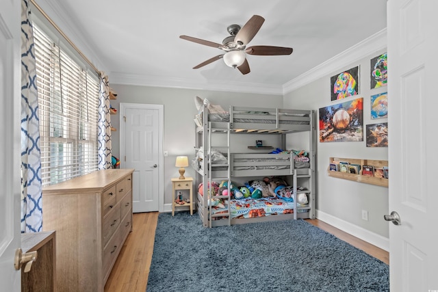 bedroom with ceiling fan, ornamental molding, and light wood-type flooring