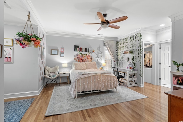 bedroom featuring hardwood / wood-style floors, ceiling fan, and crown molding