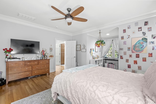 bedroom featuring wood-type flooring, ceiling fan, and ornamental molding