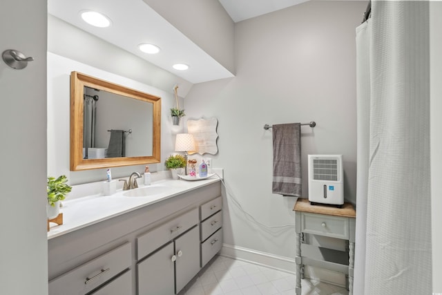 bathroom featuring tile patterned floors, heating unit, and vanity