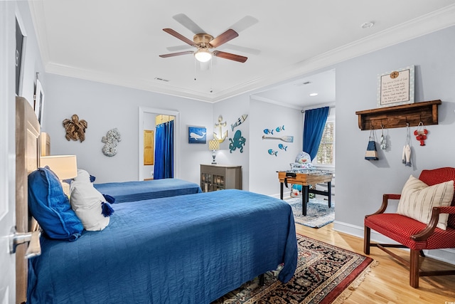 bedroom featuring ceiling fan, hardwood / wood-style floors, and ornamental molding