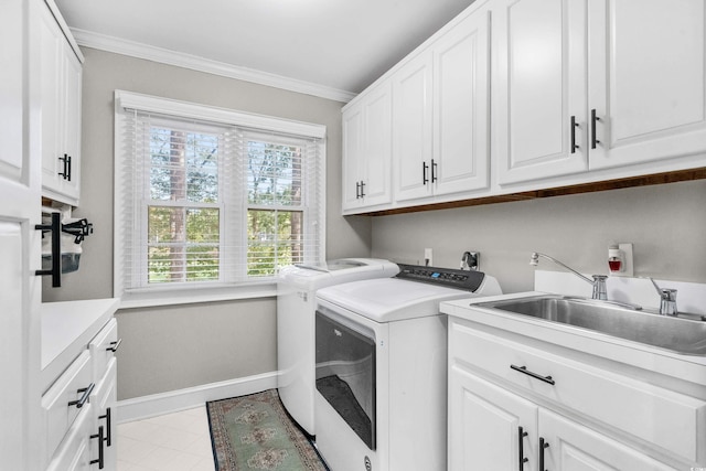 laundry area with cabinets, crown molding, sink, separate washer and dryer, and light tile patterned floors