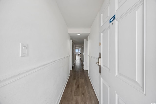 corridor with dark hardwood / wood-style floors