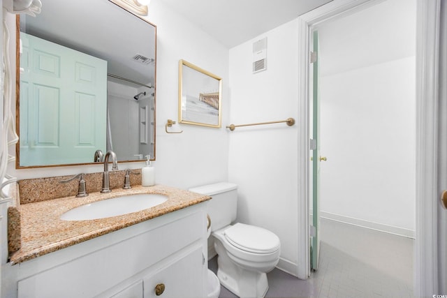 bathroom featuring tile patterned flooring, vanity, and toilet