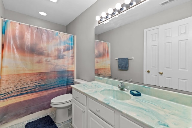 bathroom featuring tile patterned floors, a shower with curtain, vanity, and toilet